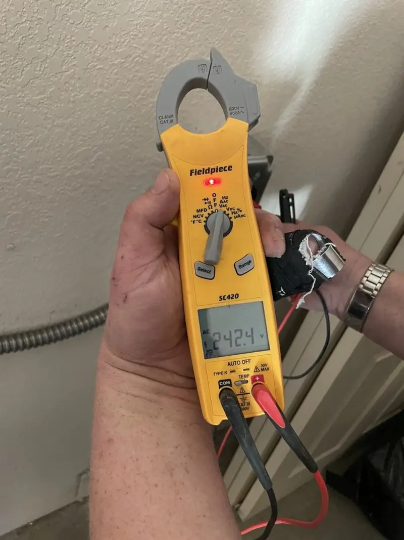 Voltage testing with clamp meter during Recessed Lighting Installation in East Milton